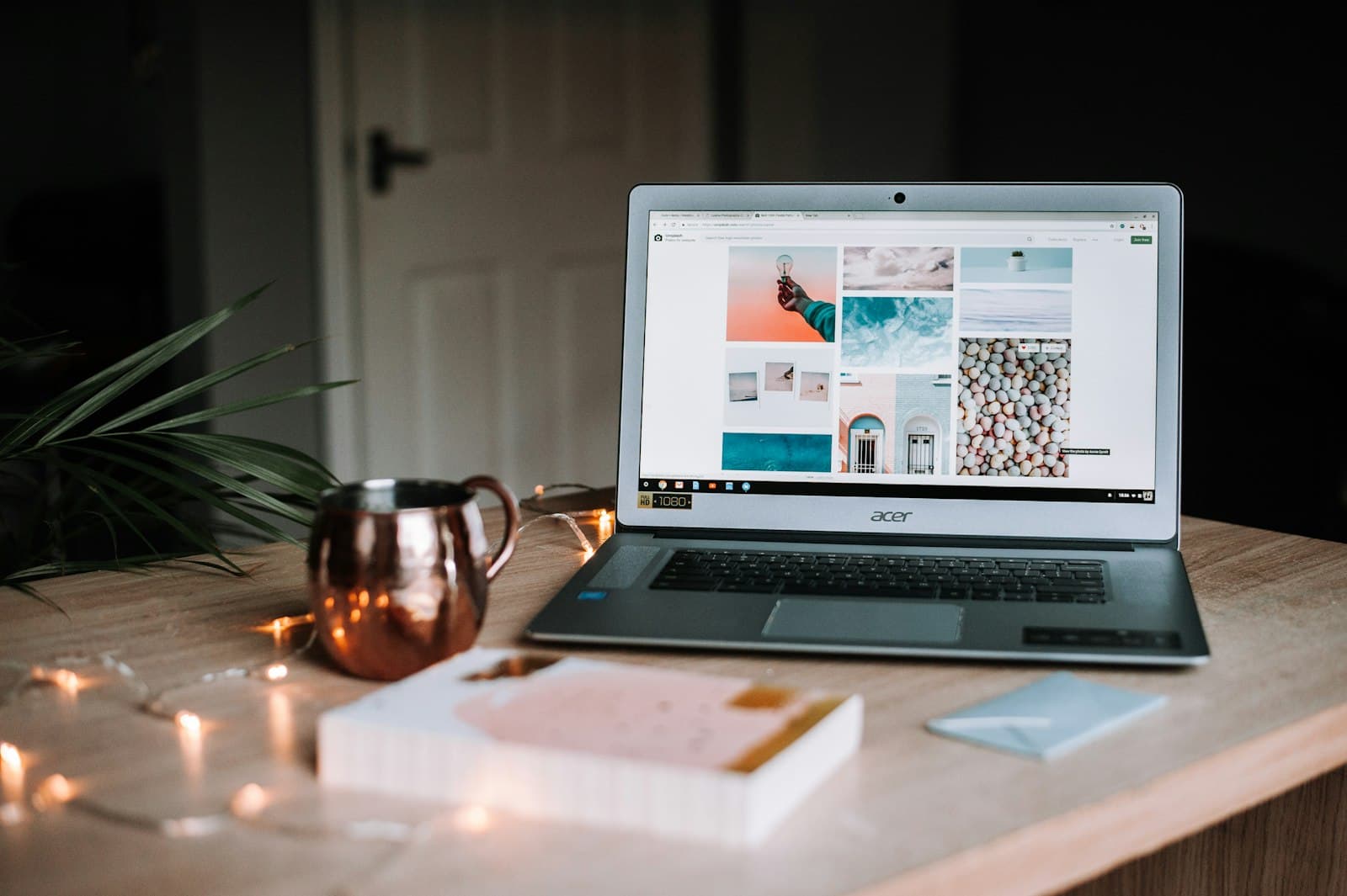 Planning trip costs on a laptop at a desk with a coffee