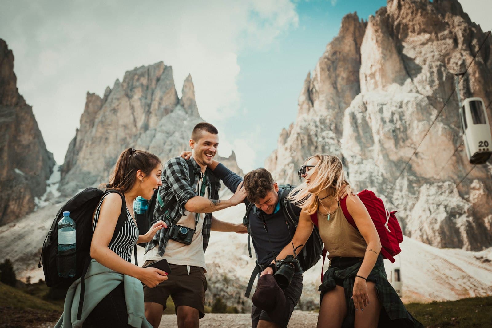 A group of friends laughing together on a trip in the mountains