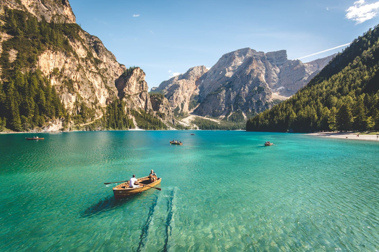 A small rowing boat on a clear mountain lake, a classic group trip destination